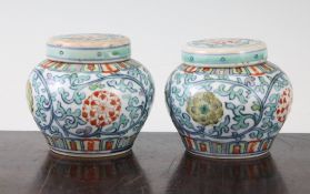 A pair of Chinese doucai small ovoid jars and covers, Yongzheng marks but later, decorated with