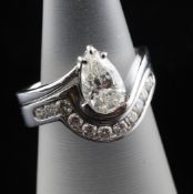 An 18ct white gold and diamond set pear shaped solitaire diamond ring and diamond set shaped wedding