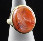 A gold and carnelian set intaglio ring, carved with bust of a classical gentleman to sinister,