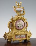 A 19th century French gilt metal and porcelain mantel clock, decorated with flowers and cherubs, the