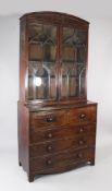 A Regency mahogany and satinwood banded secretaire bookcase, with arched pediment, two gothic arched