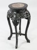 A Chinese rosewood jardiniere stand, with circular rouge marble inset top, the frieze carved and