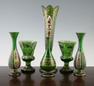 Six German or Bohemian decorated green glass vases, late 19th century, three overlaid in white glass