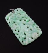 A Chinese green and white jadeite pendant plaque, 19th / 20th century, carved and pierced with