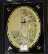 An early 19th century oval needlework panel, depicting a young girl standing by a tree, within a