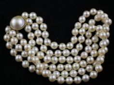 A triple strand cultured pearl choker necklace, with gold and mother of pearl set clasp, 14in.