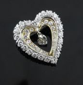 A two colour gold and diamond set concentric heart brooch, with central pear shaped diamond drop,
