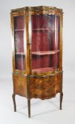A Louis XV style serpentine gilt mounted and marquetry inlaid vitrine, with single glazed door