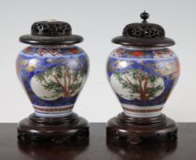 A pair of Japanese Imari small ovoid vases, Edo period, each painted with reserves of bamboo on a