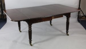 A 19th century mahogany extending dining table, with drop end flaps and two extra leaves, on