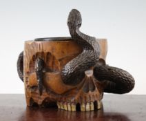 A Japanese wooden skull `jar`, late 19th / early 20th century, carved as a skull with a snake