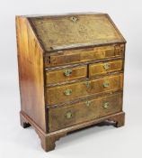 An early 18th century walnut and feather banded bureau, the fall front revealing a stepped