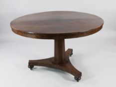 A William IV rosewood circular breakfast table, with tapering octagonal column, platform base and