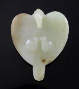 A Chinese greenish-yellow jade carving of a hunting eagle, probably Liao dynasty, of heart shape,