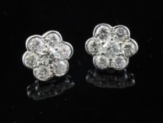 A pair of 18ct white gold and diamond cluster ear studs, of flower head design, with an total