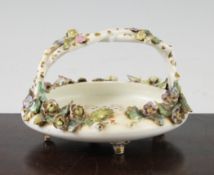 A Rockingham flower encrusted basket, c.1830, painted to the centre with a named view of All