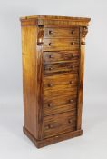 A Victorian mahogany secretaire Wellington chest, the central secretaire drawer modelled as two