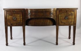 A George III mahogany breakfront sideboard, with bow shaped central drawers between two deep drawers