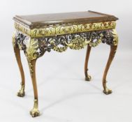 A 17th century style carved walnut and parcel gilt cabinet stand, the frieze pierced with lions,