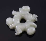 A Chinese pale grey jade carving of boys forming a ring, 18th century, when viewed from different