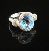 A 14ct white gold blue topaz and diamond set dress ring, with fancy oval cut topaz and diamond set