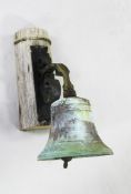 A 19th century cast ship`s bell, on a scrolled wrought iron bracket, together with a framed