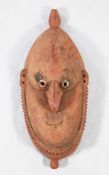 A 20th century Papua New Guinea Sepik River wall mask, with hook nose and terracotta pigments,