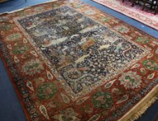 An Isfahan part silk hunting carpet, decorated with wild animals, winged figures and figures on