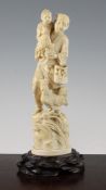 A large Japanese walrus ivory group of a man, boy and chickens, standing on a naturalistic mound