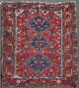 A 1920`s South Persian Khamseh rug, with three central stepped medallions, in a field of birds and