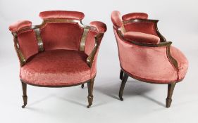 A pair of Edwardian mahogany boxwood and marquetry inlaid tub shaped chairs, with pink upholstered