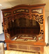 An early 20th century Chinese opium bed, with carved and inlaid bone decoration, with a pierced