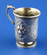 A Victorian silver christening can, embossed with panels of fruit and engraved with "scale"