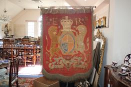 An Edwardian needlework banner, depicting the Royal coat of arms, with red fabric back and gold