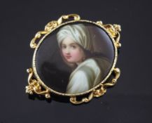 A gold mounted painted enamel brooch, of oval form decorated with portrait of a young girl, with