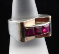 A stylish French Art Deco silver, gold and synthetic ruby dress ring, with raised curved setting set