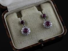 A pair of Edwardian platinum, ruby and diamond set cluster drop earrings, 0.75in.