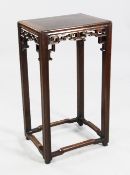 A Chinese rosewood rectangular jardiniere stand, with traditional carved and pierced frieze, on