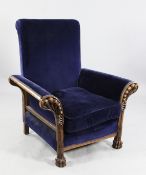 A late Victorian Art Nouveau oak framed armchair, with scroll over arms carved and pierced with