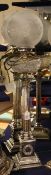 A 20th century silver plated corinthian column table lamp, now converted to electricity, with cut