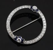 An early 20th century platinum, diamond and sapphire circular brooch, of openwork form, Swiss