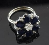 A white gold, sapphire and diamond set cluster ring, of flowerhead design, size K.