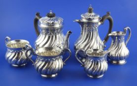 An Edwardian six piece silver tea and coffee set by S.J. Phillips Ltd, of spiral fluted baluster