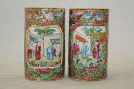 A pair of Chinese famille rose cylindrical brush pots, mid 19th century, each moulded in relief