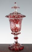 A Bohemian ruby flashed clear glass goblet and cover, late 19th century, the bell shaped bowl