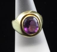 An early 1970`s 18ct gold and solitaire amethyst ring by Kutchinsky, set with a fancy oval cut