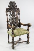 A Continental late 17th century style carved beech high back open armchair, with pierced acanthus