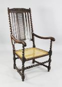 A Carolean walnut open armchair, with barley twist uprights and caned back and seat