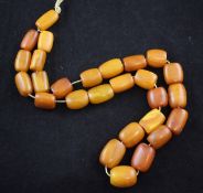 A single strand graduated amber bead necklace, with barrel shaped beads, gross 52 grams, 20in.