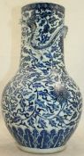 A Chinese blue and white `lotus` vase, 19th century, the broad neck modelled with a dragon, 36cm.